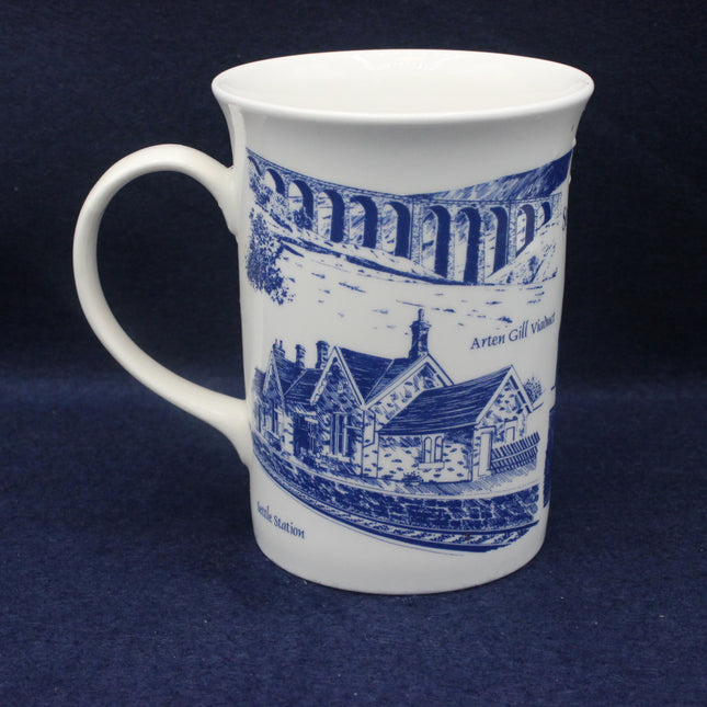 White mug with blue architectural design on a dark blue background
