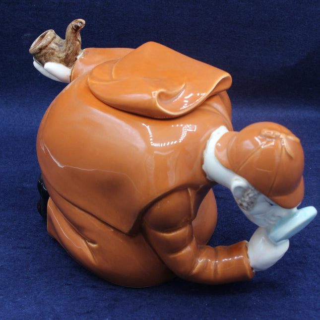 Brown ceramic teapot with a lid on a blue background