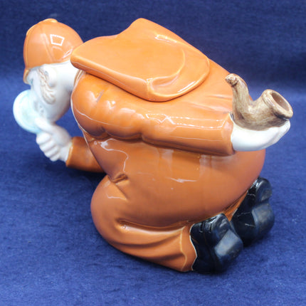Decorative figurine of a character in orange outfit on a blue background