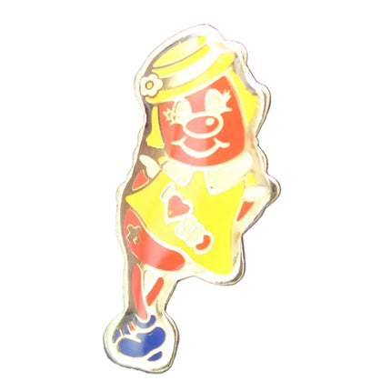 Colorful clown pin on a blue fabric background