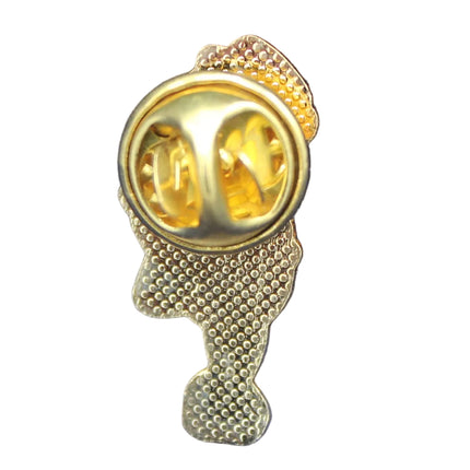 Gold brooch with two circular stones on a blue textured background