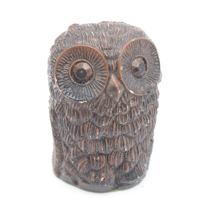 A small decorative owl figurine with a textured, metallic bronze finish, photographed against a solid white background.