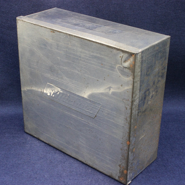 Metal box with visible wear on a blue background