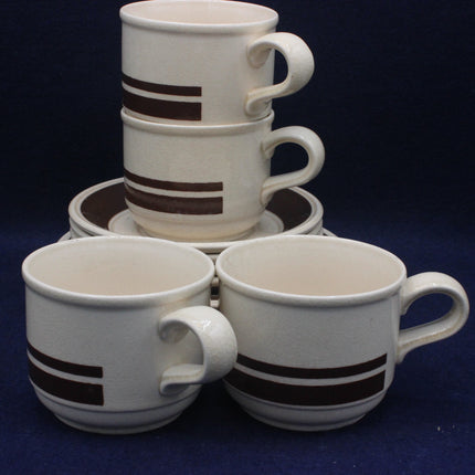 Set of white ceramic mugs with brown stripes on a dark blue background