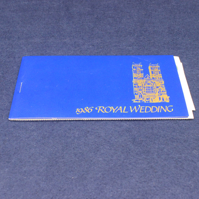 Blue book with '1986 Royal Wedding' text and a building illustration on a blue background