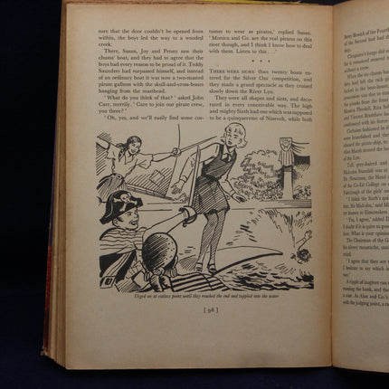 Open book with black and white illustrations and text on a dark background