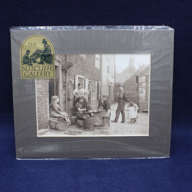 Packaged artwork from The Sutcliffe Gallery with a black and white scene of people in an alleyway.