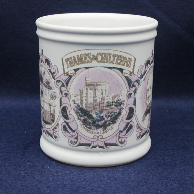 White ceramic mug with decorative purple design and text on a blue background