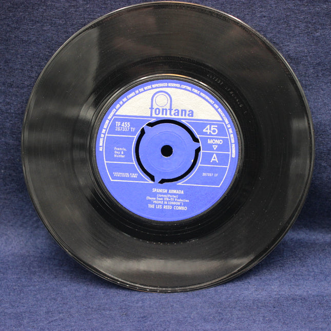 Black vinyl record with blue label on a blue background