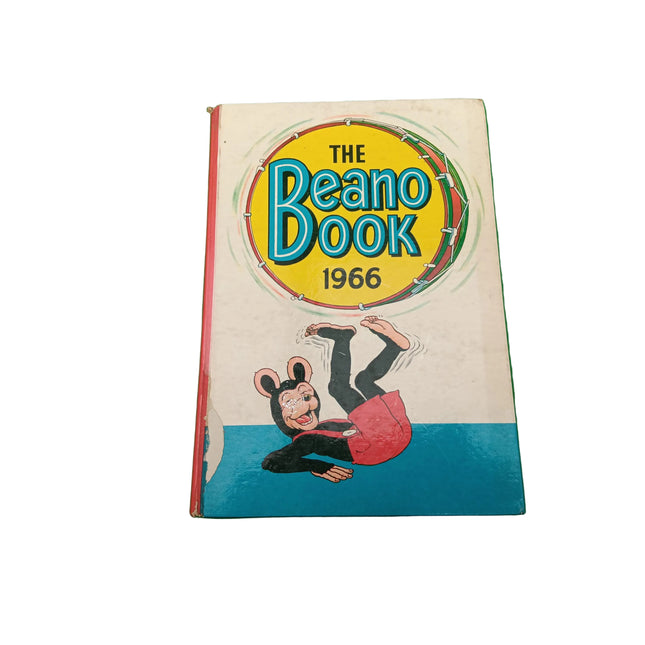 Vintage comic book titled 'The Beano Book 1966' featuring a cartoon mouse character on the cover, photographed on a green surface.