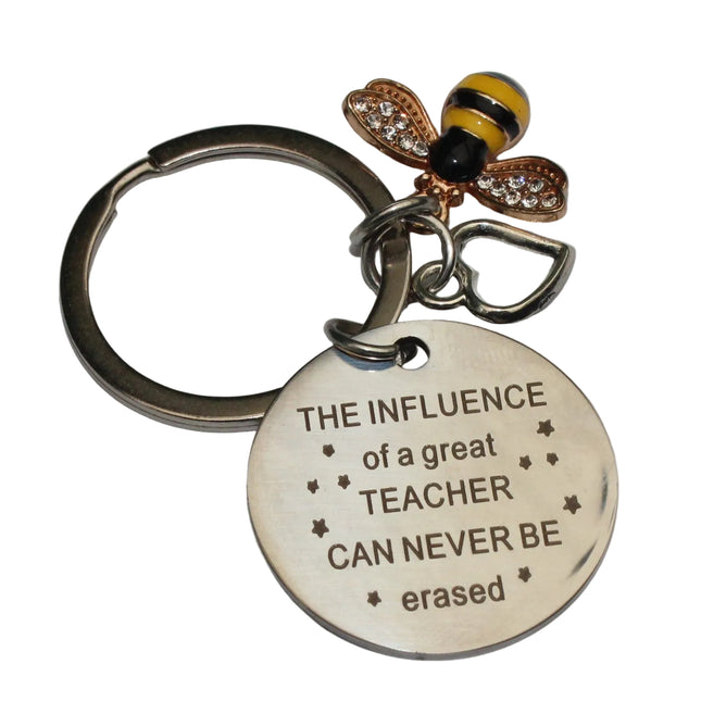 Keychain with bee charm and engraved message on a gray background