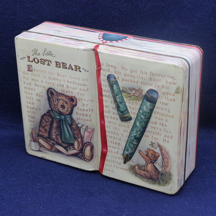 Small book with a teddy bear illustration on a blue background