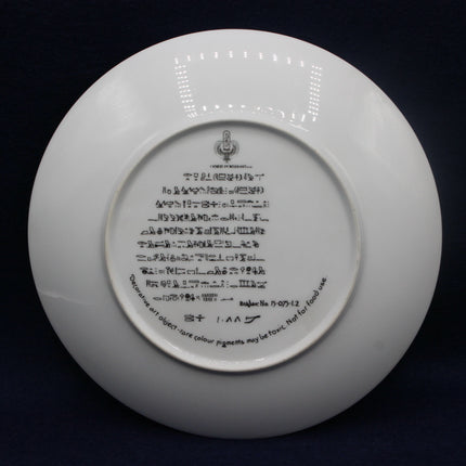 White plate with black text on a dark background