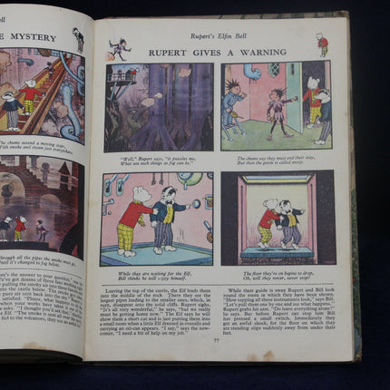 Open book with illustrated pages featuring Rupert Bear, a classic British comic strip character.