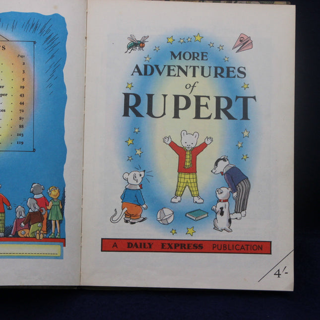 Book cover of 'More Adventures of Rupert' with Rupert Bear and friends on a blue background.