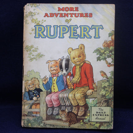 Vintage book cover of 'More Adventures of Rupert' featuring cartoon characters on a blue background