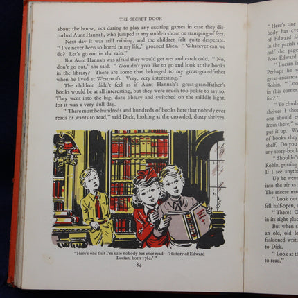 Open book with illustrated page showing children in a library.