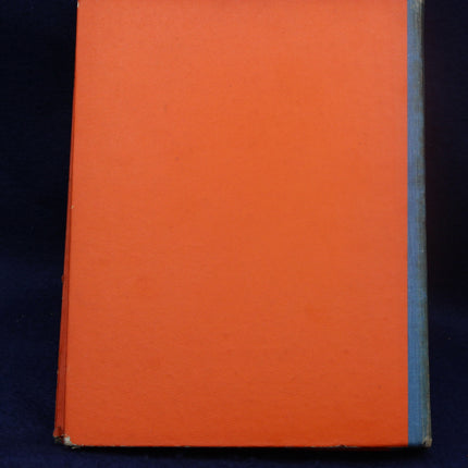 Close-up of an orange book on a dark background