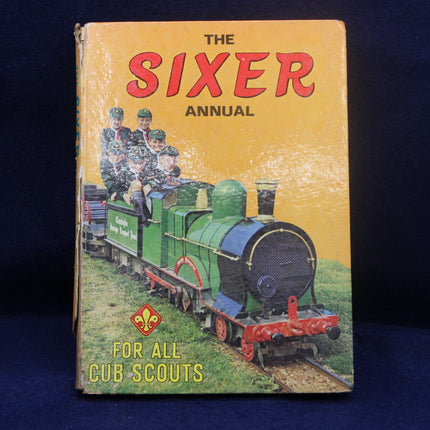 Vintage book titled 'The Sixer Annual for All Cub Scouts' with a train illustration on the cover.
