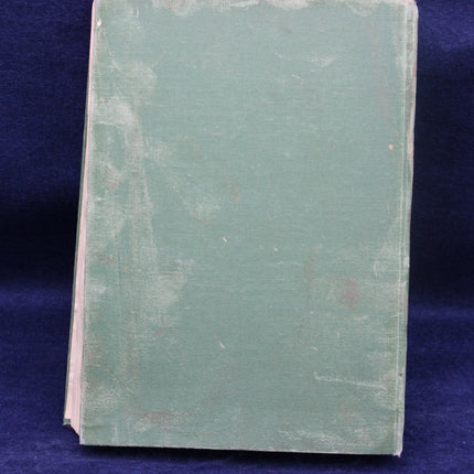 Vintage green book on a blue background