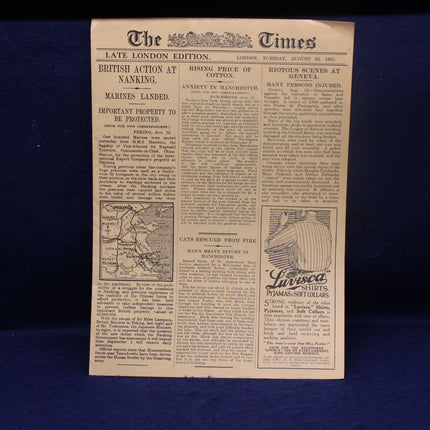 Vintage newspaper from 'The Times' with text and a map on a blue background