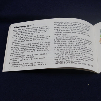 Open book with a page titled 'Playing ball' on a dark background