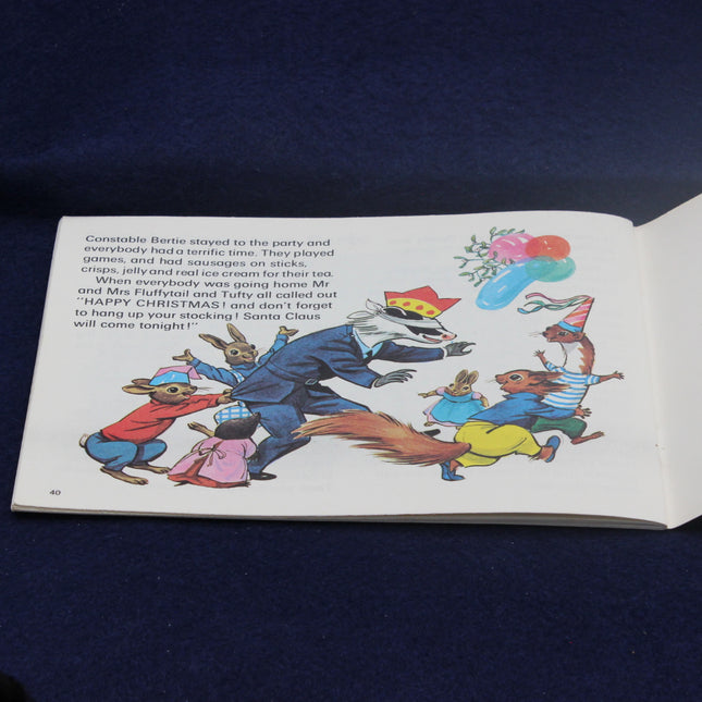 Open book with Christmas-themed illustrations on a dark blue background