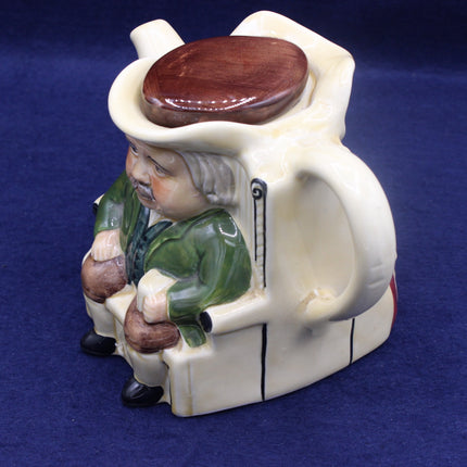Ceramic figure of a man with a wooden hat and pipe on a blue background