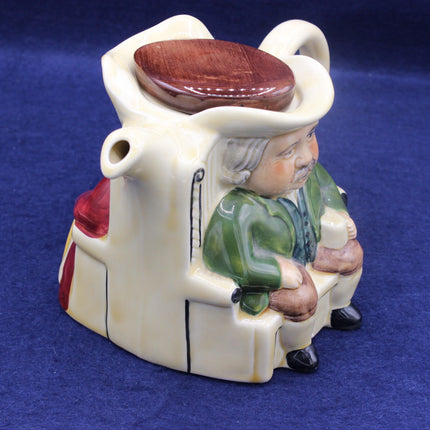 Ceramic figure of a person sitting on a toilet with a blue background