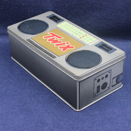 Twix candy bar packaging with a retro control panel design on a blue background