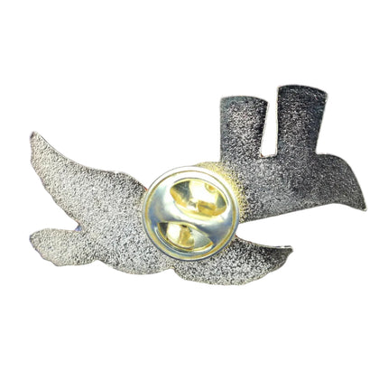 Metallic pin with wings on a blue textured background