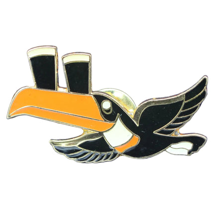 Bird-shaped pin with orange beak and black body on a blue textured background