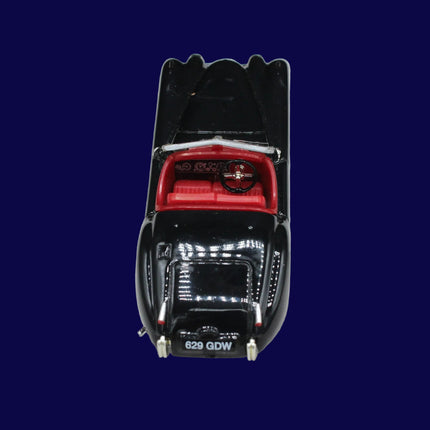 Black and red model car on a blue background