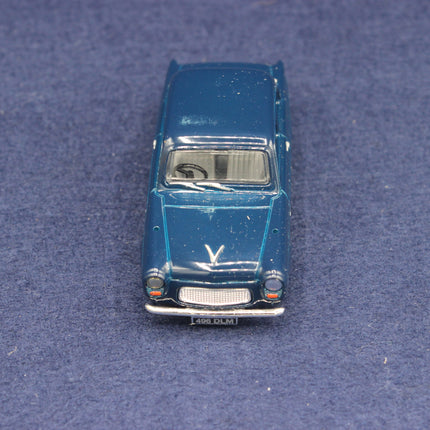 Blue toy car on a textured blue surface