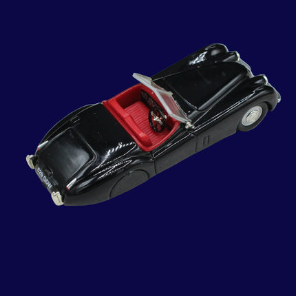 Model of a classic black car with open top on a gray background