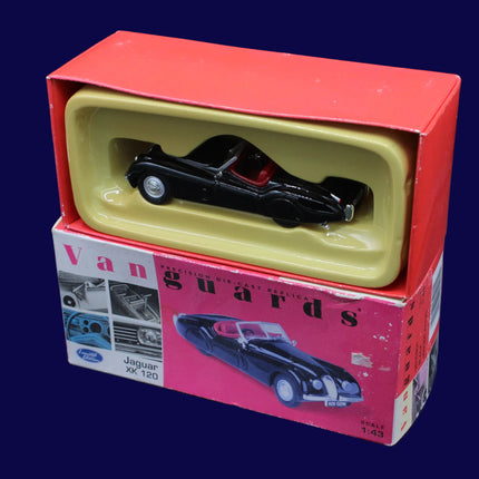 Model car in a red and yellow box with 'Vanguards' branding on a dark background