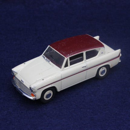 Model car with a white body and maroon roof on a dark blue background