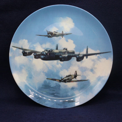 Decorative plate with vintage airplane design against a blue sky with clouds