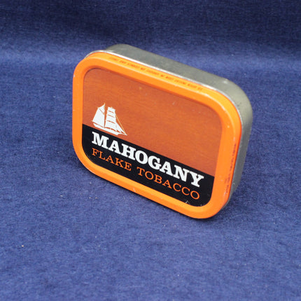 Mahogany Flake Tobacco tin on a blue background