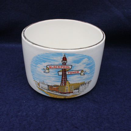 White ceramic cup with Blackpool Tower design on a blue background