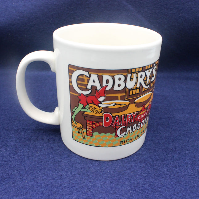 White mug with Cadbury Dairy Milk Chocolate branding on a blue background