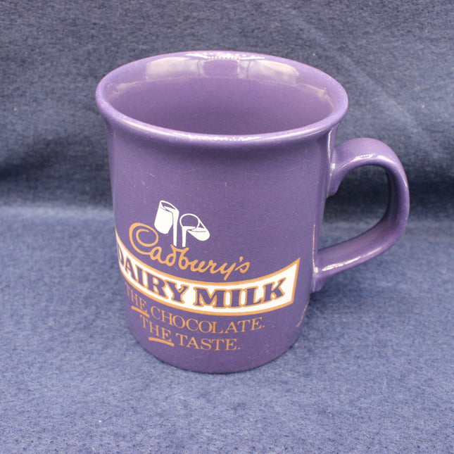 Purple mug with Cadbury's Dairy Milk branding on a gray background