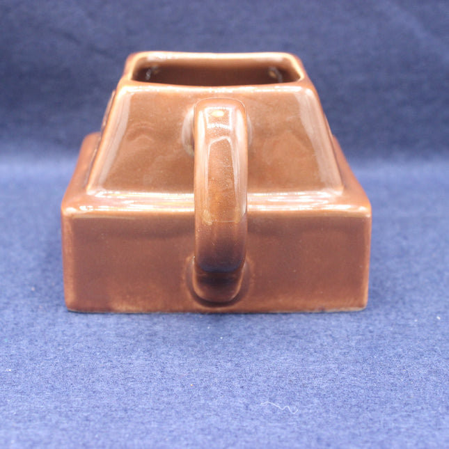 Brown chocolate block ceramic mug with a handle on a blue background