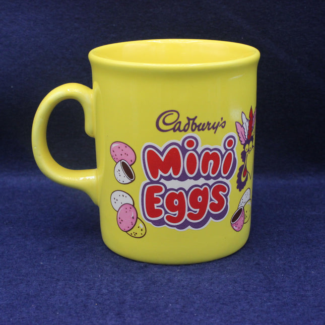 Yellow mug with Cadbury's Mini Eggs branding on a blue background