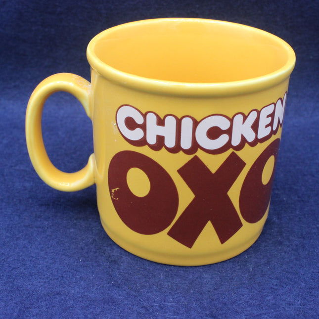 Yellow mug with 'Chicken Oxo' text on a blue background
