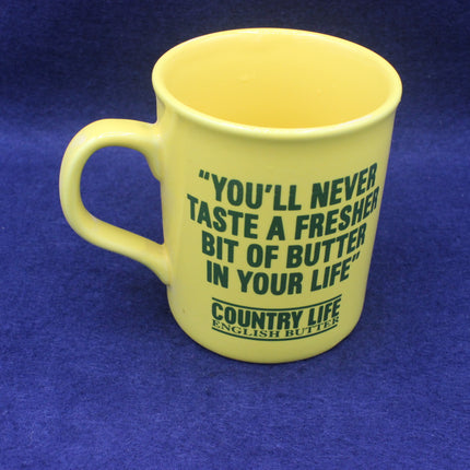 Yellow Country Life Butter mug with green text on a blue background