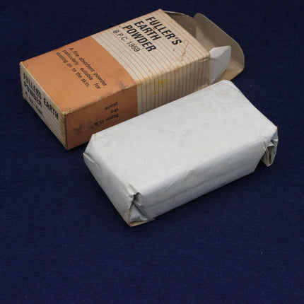 Bar of Fuller's Earth powder with packaging on a dark blue background