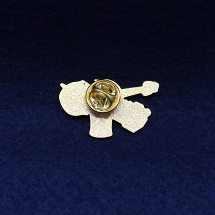 Decorative brooch with a central clasp on a dark blue fabric background