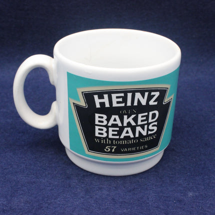 White mug with Heinz Baked Beans label on a blue background