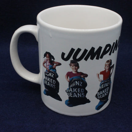 White mug with Heinz baked beans graphic and 'Jumpin' text on a dark background